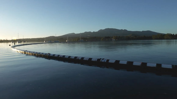 A pool of water, with a separator dividing the water and mountains in the background.