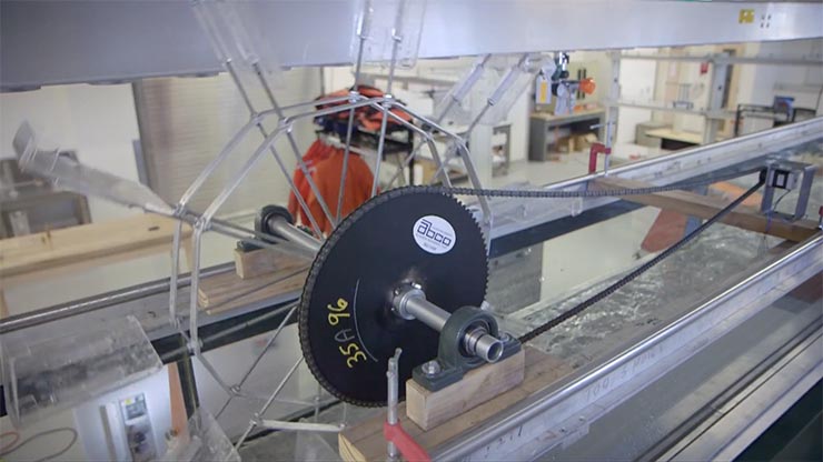 A gear with branding that reads ABCO connected to a marine energy device in a testing facility.