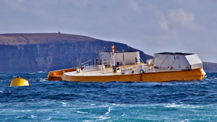 A yellow buoy floating next to an orange-and-white ship with a cliff in the background.