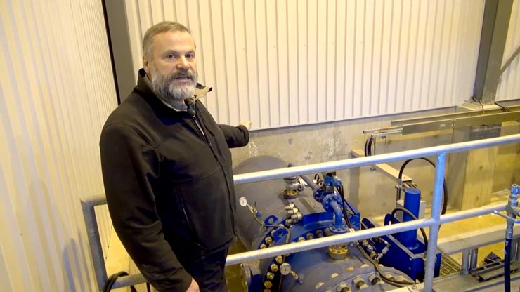 A communication tower with a dark blue sky in the background